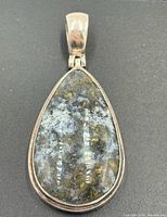Front view of teardrop jasper pendant in sterling setting