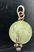 Front view of spherical prehnite pendant