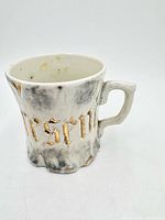 Front view showing gold lettering and marbled effect