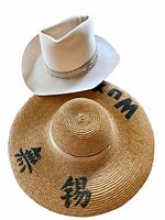 Top view of both hats showing styles and painted symbols