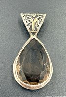 Front view of pendant showing stone, bezel, and bail detail