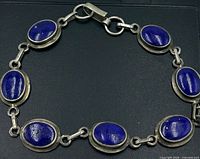 Entire bracelet laid flat showing seven lapis stones and clasp