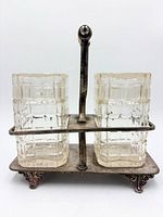 Front view of silver-plated caddy with two square cut-glass bottles