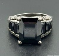 Front view showing center square-cut black onyx and side stones