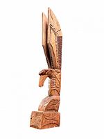 Front angle view of full totem pole showing Thunderbird carving and base