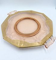 Top view of pink depression glass plate showing gold rim and etched pattern