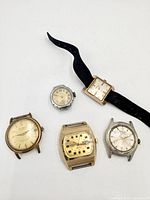 Group shot of all five wristwatches laid out