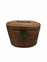 Front angled view of closed oval wicker basket showing latch and handle