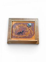 Front view of framed leather relief artwork
