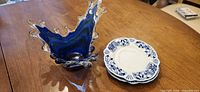 Overall view showing cobalt splash bowl and stack of blue/white saucers