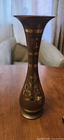 Full view of brass hand-etched floral bud vase