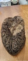 Oblique top view of brown astrakhan fur hat