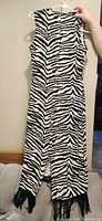Full front of sleeveless zebra print maxi dress showing fringe hem