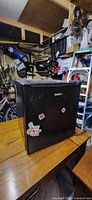 Front view of black Galanz mini fridge showing overall exterior condition