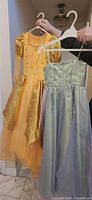 Front view of both dresses hanging