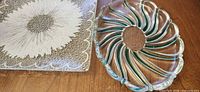 Square plate and round swirl dish on table