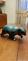 Side view of ceramic bear showing overall form and glaze