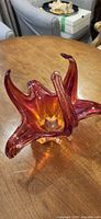 overall view of red-orange freeform glass bowl on table