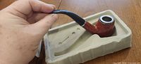 Pipe in molded tray showing bowl, stem, silver ring