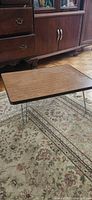 Top view of rectangular wood veneer folding TV tray table with hairpin legs