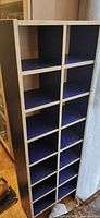 Front view of tall cubby shelf showing twelve compartments and color scheme