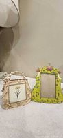 Handbag-shaped beige frame and dress-shaped green frame displayed front view