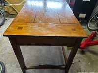 Top and front view of oak mission writing desk showing wood grain, mortise detail, stretcher rails, and overall finish