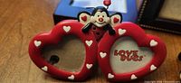 Close-up of red Love Bugs double-heart frame