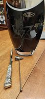 Vase front with star motif and candle snuffer laid beside