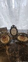 Front view of three Russ antique bronze oval frames