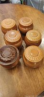 Six lidded brown ceramic canisters top view