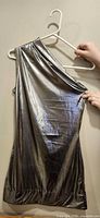 Full front view of silver metallic one-shoulder bodycon dress on hanger