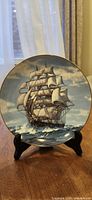 Front view showing clipper ship artwork and gold rim
