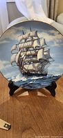 Front of plate on stand showing clipper ship artwork