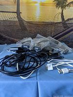 Stack of sealed StarTech adapters and assorted loose cables visible
