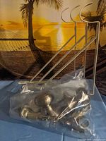 overall lot showing three plant hanger brackets and bag of door hardware