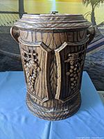 Full exterior view of barrel-style ice bucket showing grape motif and wood-grain finish