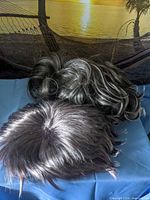 Top view of both wigs showing colors and styles