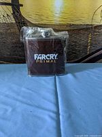 Front view of sealed Far Cry Primal brown leather-covered hip flask