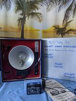 Flash unit, manual, box interior, sync cord foot controller displayed