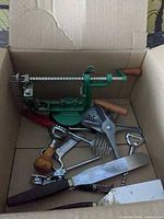 Boxed assortment showing green apple peeler and various utensils
