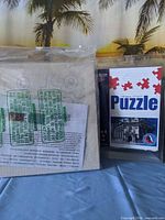 Canvas panel beside sealed architecture puzzle package