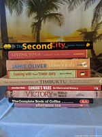 Front view of stacked hardcovers showing titles and authors