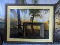 Large brown wood frame with beige-gold liner nested with smaller dark frame