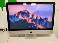 Front view of iMac showing 27-inch screen and login interface