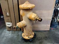 Full view of yellow cast iron fire hydrant front