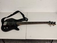 Full view of bass guitar with strap attached