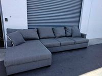 Full view of sectional sofa showing chaise orientation and overall condition