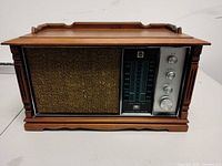 Front view showing grille, tuning dial and knobs