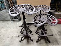 Four DIWHY cast-iron adjustable stools grouped together full view